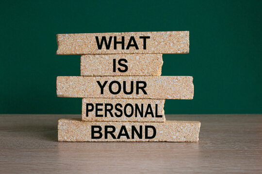 What is your personal brand symbol. Concept words What is your personal brand on brick blocks. Beautiful wooden table, green background. Business what is your personal brand concept. Copy space.
