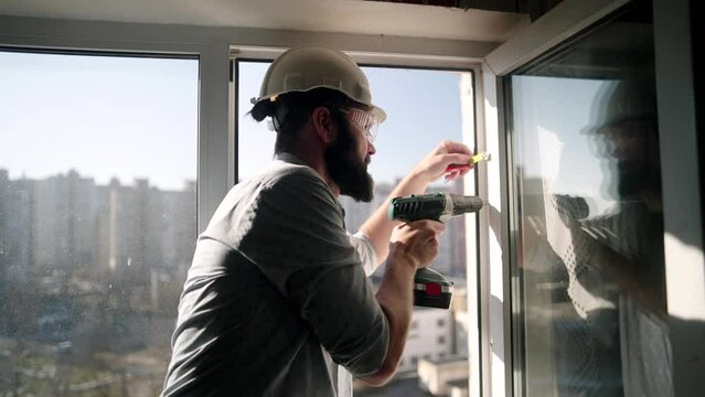 Builder installs plastic windows and furniture	