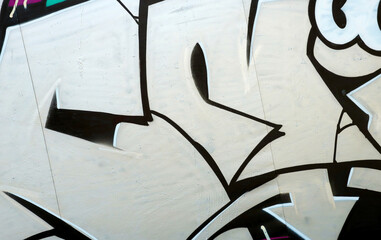 Colorful background of graffiti painting artwork with bright aerosol outlines on wall. Old school...