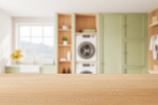 Mock up wooden counter and blurred laundry room interior with washing machines