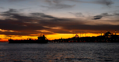 Fototapeta na wymiar Big silhouette of cargo ship in the Marmara sea, Turkey. Coastline of Istanbul