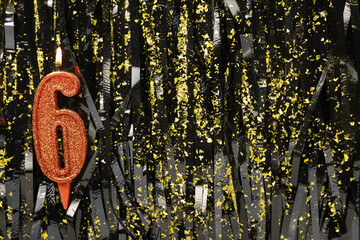 Burning red birthday candles on dark glitter background, number 6
