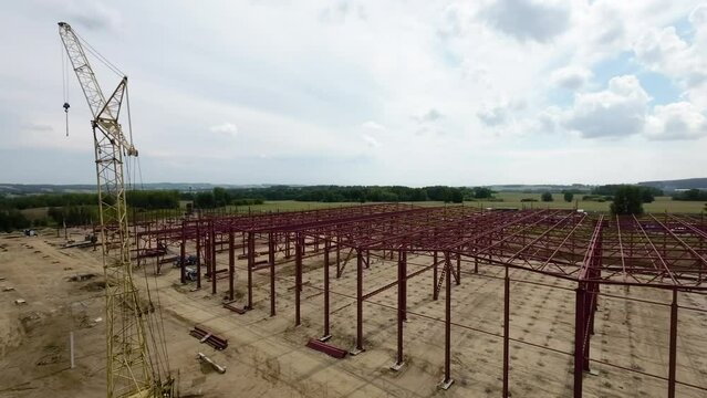 View of the construction site of a large factory in the countryside, filming an aerial video