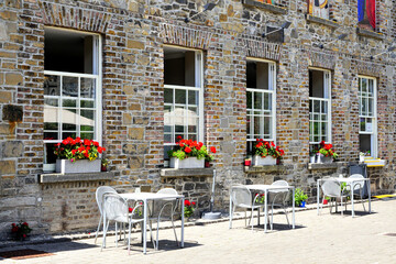Quaint outdoor restaurant in Dublin, Ireland. Tables outside a historic stone building with flowers.