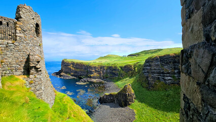 Northern Ireland view of the green Causeway coast through ancient castle ruins