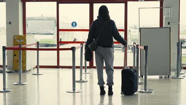 young woman traveler waiting at airport