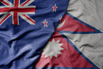 big waving national colorful flag of nepal and national flag of new zealand .