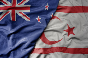 Fototapeta premium big waving national colorful flag of northern cyprus and national flag of new zealand .