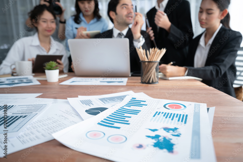 Aufkleber piles of analyzed financial data dashboard on meeting table with background of business people analy