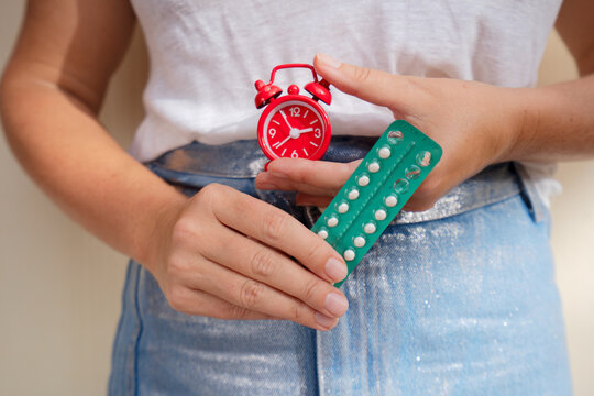 woman holding 21 day oral contraceptive pills, birth control and pregnancy planning