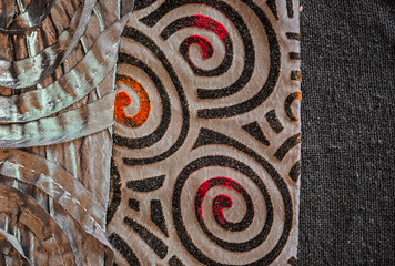 Textile background of red and black gray fabric printed with relief and spiral