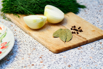 Onion Cut in Half. Black Pepper and Dry Bay Leaf. Bunch Fresh Dill. On Wooden Board.