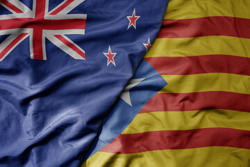 big waving national colorful flag of catalonia and national flag of new zealand .