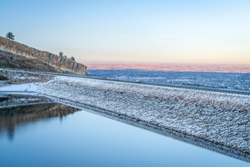 winter dusk over frozen Horsetooth Reservoir and dam at foothills of northern Colorado with...