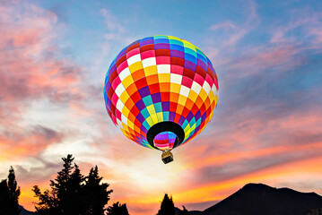 Colorful hot air balloon flying at sunset	