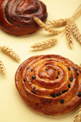 Freshly baked sweet bun with chocolate on beige background, top view