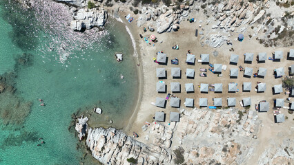 Aerial drone photo of famous small organised beach with unique rock formations of Kolimbithres or Kolympithres in the gulf of Naousa, Paros island, Cyclades, Greece - obrazy, fototapety, plakaty