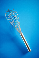 Metal wire whisk on a table