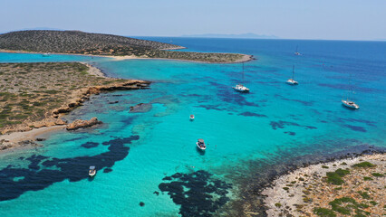 Aerial drone photo from tropical exotic paradise secluded rocky island bay with deep turquoise and...