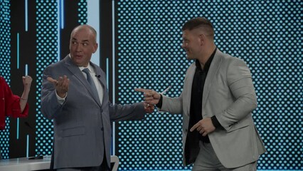 Male contestant answering the questions in final quiz round during recording of a fictional morning family game show