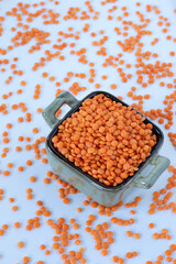 Fototapeta na wymiar Red lentils in a bowl isolated on white background. Healthy organic legume food concept.