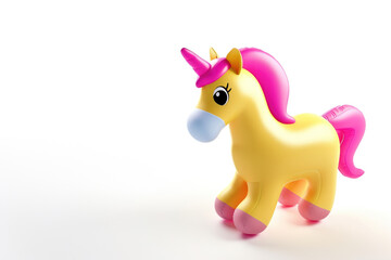 A yellow inflatable toy unicorn with a pink mane.