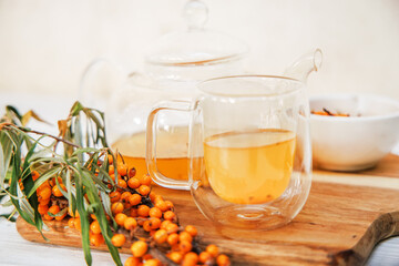 Clear teapot with sea buckthorn tea, a medley of flavors and health benefits.