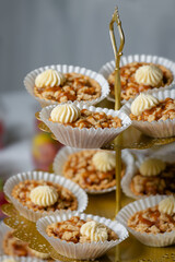 Birthday cupcakes on three tiered display stand close up background