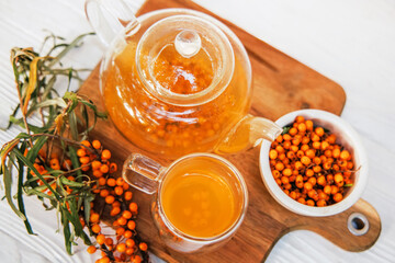 Clear teapot with sea buckthorn tea, a medley of flavors and health benefits.