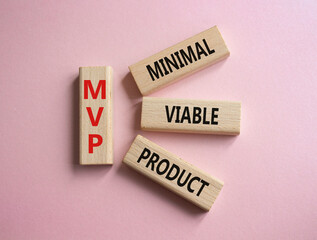 MVP - Most Valuable Player symbol. Wooden cubes with words MVP. Beautiful pink background. Business and MVP concept. Copy space.