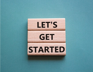 Lets get started symbol. Concept words Lets get started on wooden blocks. Beautiful grey green background. Business and Lets get started concept. Copy space.