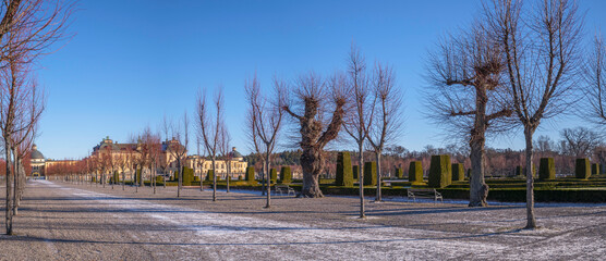 Fototapeta na wymiar Park and castle in the Drottningholm island, a sunny winter day in Stockholm