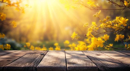 Tuinposter Wooden table with a sunny spring background and blooming yellow flowers ideal for product display © Another vision