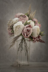 Still life bouquet of soft pink and white peonies