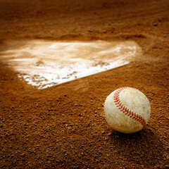 Old Leather Baseball on Field by Home Plate or Base