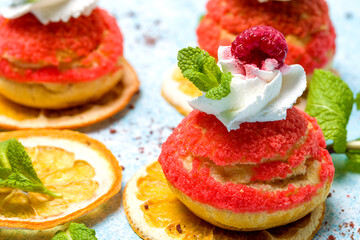 Shu cake. Custard dessert with creamy white cream, decorated with raspberries