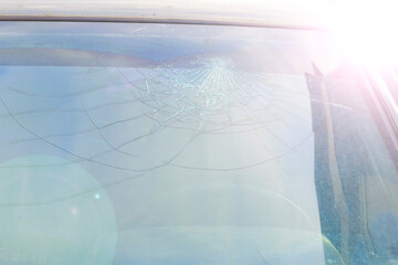 broken car windshield. a crack in the glass after an accident or a stone hit