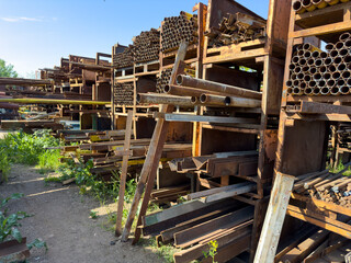 Old rusty iron pipes on racks