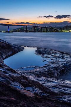 View of the third bridge, which connects the cities of Vila Velha and Vit&oacute;ria during a late afternoon with colorful sky reflected in the natural pool