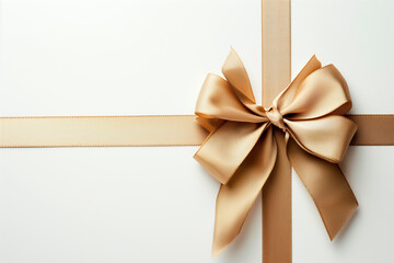Fototapeta premium Elegant gold ribbon bow on white background, top view, gift concept.