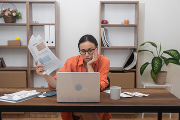 woman settles domestic bills online via a computer app, while a bank customer handles credit insurance payment at home with paperwork