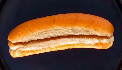 Hot Dog preparation, freshly baked bun, close up. Homemade hot dog cooking. Grocery product advertising, menu or package, selective focus.