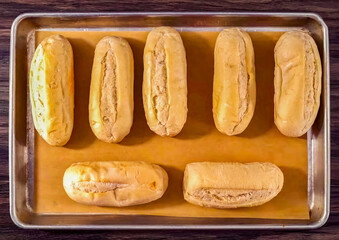 Hot Dog preparation, freshly baked buns, close up. Homemade hot dog cooking. Grocery product advertising, menu or package.