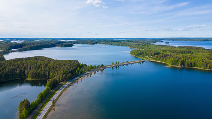Typical finnish landscape with blue lakes, forest and a scenic road