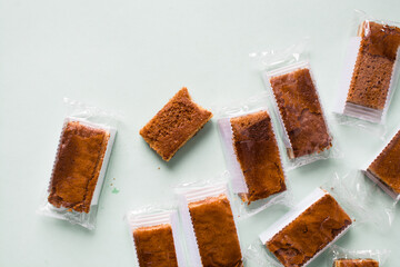 Cakes individually wrapped in plastic packaging, unsustainable product packaging, mini cakes in...