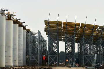 A large-scale construction project of a highway bridge with concrete and steel structures. Building...