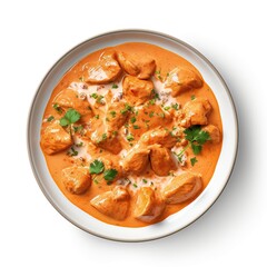 Butter chicken creamy tomato-based sauce on a plate top view isolated on a white background