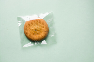Handheld pies or cookies in plastic bag, cookies in unsustainable packaging, top view of recyclable bakery packaging