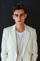 Obraz premium A Professional portrait model of a white young man wearing a white suit and a T-shirt 