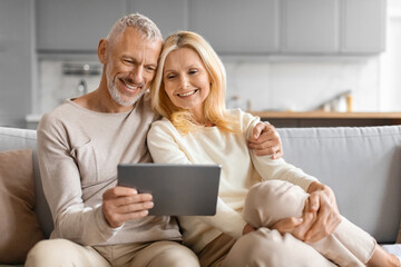 Happy Senior Couple Using Digital Tablet Together Browsing Internet